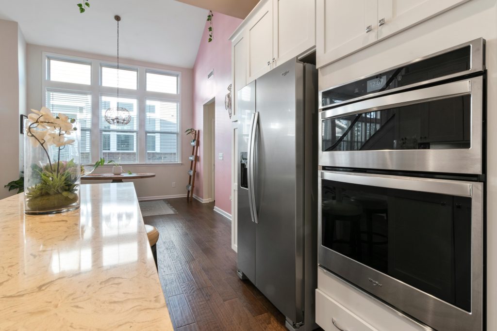 Spacious modern kitchen featuring stainless steel appliances and large windows with ample natural light.